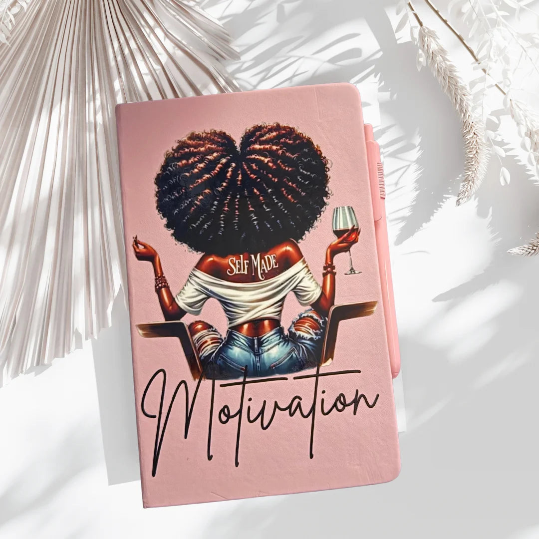 Luxury pink hardcover “Self Made Motivation Journal” with bold motivational artwork and premium lined pages, styled flat lay with sunlight accents
